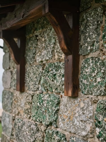 Close-up of weathered Galician granite stone wall and dark oak wood beams of an estate, soft Atlantic overcast daylight, focus on texture and craftsmanship, shallow depth of field, 35mm.