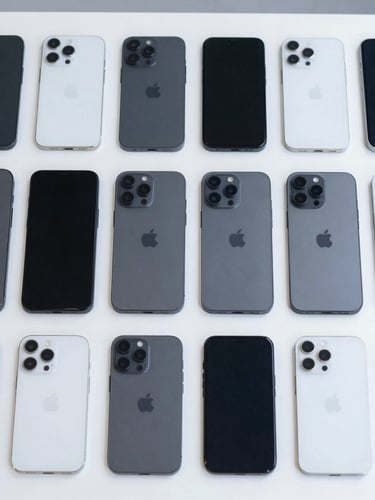 Top-down symmetrical flat lay of sorted smartphones in matte black and silver, arranged perfectly on a clean clinical sorting table under bright cool daylight, high-precision industrial aesthetic
