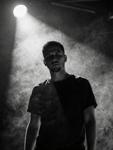 High-contrast black and white portrait of a musician lost in performance, a single sharp spotlight cutting through heavy stage smoke, dramatic chiaroscuro, grain texture.