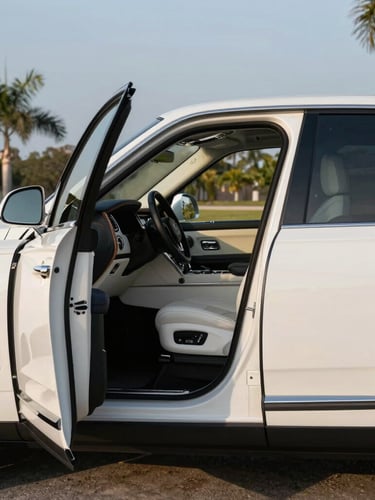Medium-shot profile of a pristine white luxury SUV parked under the soft morning Florida sun, passenger door open, clean leather interior visible.