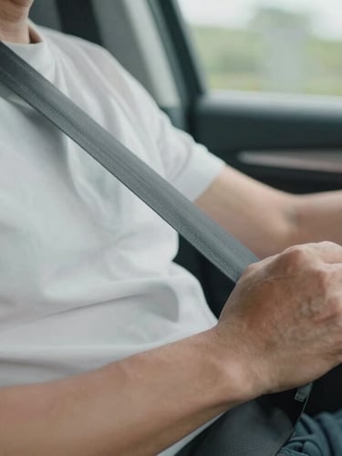 Close-up of a professional driver's hands safely securing a seatbelt for a passenger, clean vehicle interior, soft daylight filtering through the window.