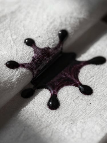 Extreme close-up of dark ink bleeding into heavy white cotton paper, high-contrast directional light, deep chiaroscuro shadows, capturing raw medium texture.