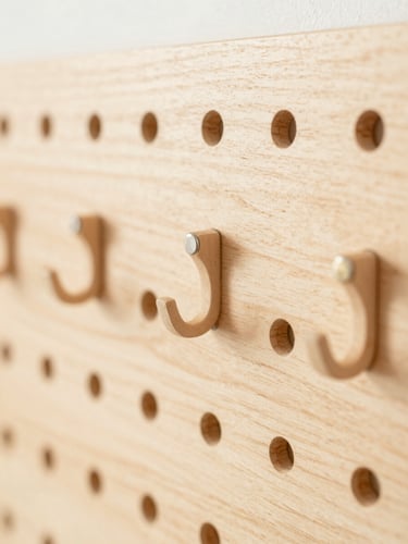 tight detail shot of modular hooks snapping into the warm wood pegboard, soft morning daylight, shallow depth of field, Japandi aesthetic