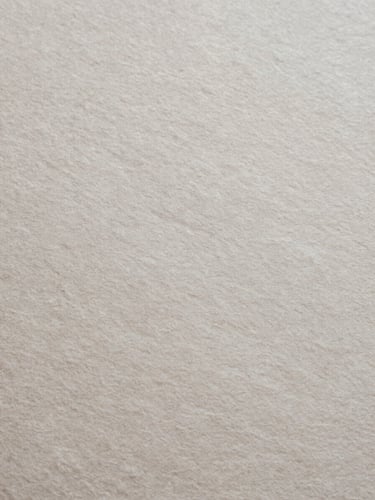 Extreme close-up of textured heavy handmade paper, soft natural overhead light, desaturated slate tones, 35mm film style.