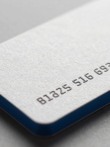 Close-up macro shot of premium textured business cards with electric blue edges, bright studio lighting, shallow depth of field