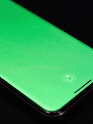 Extreme macro close-up of a high-end Android phone screen showing a fluid, glowing neon green UI interface, dark studio lighting, sharp reflections on glass