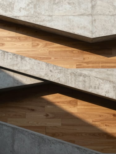 Minimalist architectural detail of overlapping concrete planes and warm wooden panels, casting soft geometric shadows in bright afternoon sun.