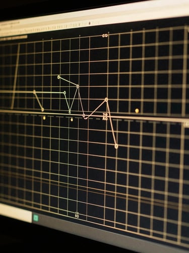 Extreme close-up of a high-performance computer monitor displaying complex GTO range charts in dark gold and black, soft focus on the mathematical grids, dramatic backlighting