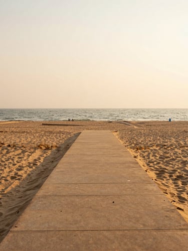 A serene pathway leading from the resort directly onto the sandy beach of Puri, warm golden-hour coastal light, 35mm lens