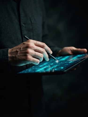 Moody studio photography, an artist's hands subtly interacting with a tablet displaying social media analytics, electric turquoise glow from the screen, dark background, shallow depth of field, portrait aspect.