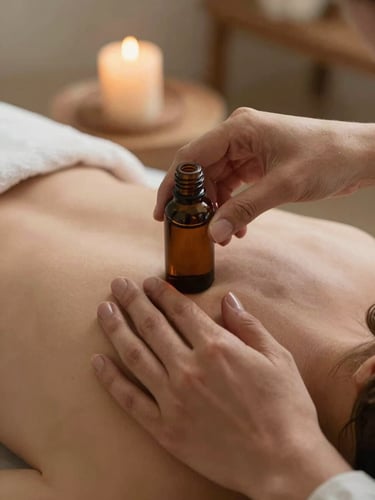Close-up of a practitioner's hands applying botanical oil to a shoulder in slow, precise motion, soft candlelight lighting, peaceful and professional atmosphere.