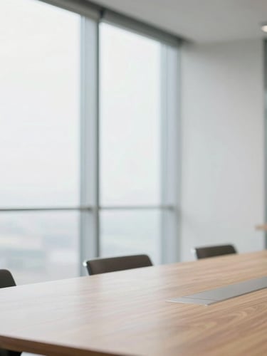 Clean geometric composition of a professional meeting room, soft daylight diffusing through glass walls, minimalist wooden table, sharp focus