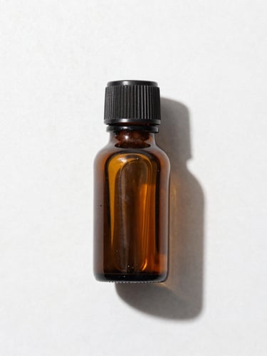 Macro overhead flat lay of a single amber glass bottle on a clean white laboratory stone surface, bright clinical high-key studio light, sharp defined shadows, 50mm lens