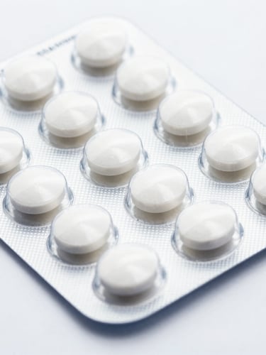Macro clinical photograph of clean white B2B pharmaceutical blister packs containing oral tablets, high-key studio lighting, sharp focus, 50mm