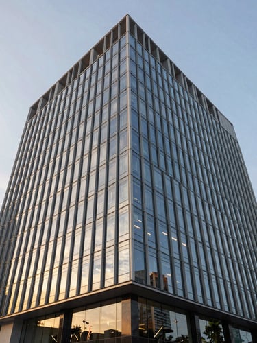 An architectural low-angle exterior shot of a modern, minimalist glass and steel commercial headquarters building in Singapore during golden hour, sharp reflections, clean geometric lines