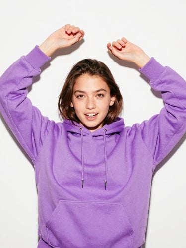 A Gen Z girl in a high-energy candid pose, wearing a vibrant electric lavender hoodie, direct flash, high contrast, 35mm lens, standing against a clean white wall.