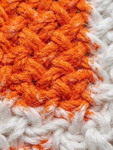 Macro studio photograph of vibrant orange ink bonding to white cotton fabric fibers, high-key clean lighting, ultra-detailed texture, sharp focus, 50mm