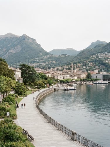 Wide environmental shot of the Lugano lakefront and surrounding mountains under bright overcast daylight, clean institutional photography, 35mm