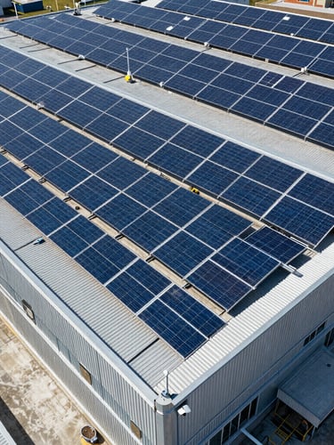 Crisp wide-angle drone shot of a massive industrial rooftop solar array under direct midday sunlight, metallic blue tones, architectural precision.