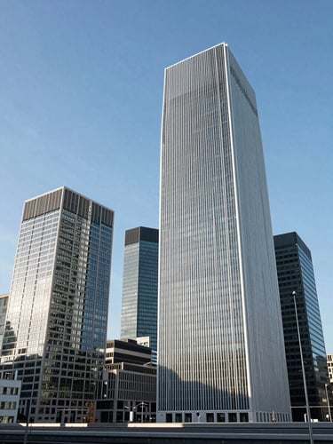 A wide-angle, bright architectural perspective of a modern financial district skyline in Brussels under clean daylight, with sharp lines and ample blue sky.
