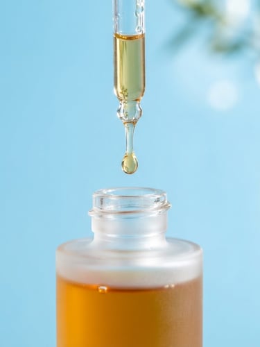 Extreme macro shot of pure botanical oil dripping from a glass dropper into a frosted glass vessel, high-key morning light, crisp sky blue background, clean geometric alignment