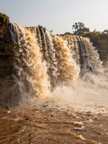 Portrait 9:16 frame of Chitrakote waterfall during golden hour, mist rising from the water, dramatic warm sunlight.