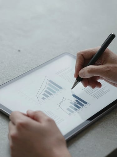 Extreme close-up of hands writing structured business diagrams on a tablet, minimalist concrete desk, cool overcast natural light, desaturated tones.