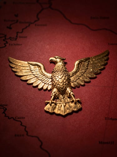 Macro shot of gold-foiled Roman eagle crest on heavy archival map, dramatic side-lighting, deep crimson shadows, 35mm