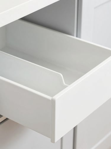 Bright high-key kitchen organization scene with neatly arranged modular drawer organizers, crisp natural studio light, soft gray background, 50mm, sharp focus