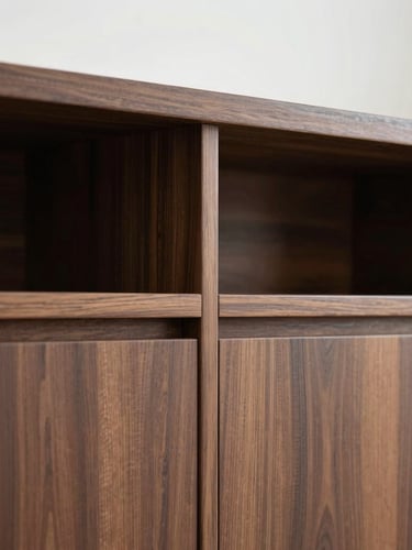 Tight detail shot of custom walnut cabinetry joinery, straight-on architectural elevation, soft diffused overcast daylight, clean lines.