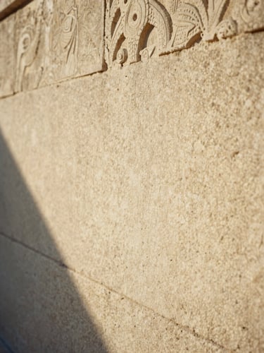 Extreme close-up of hand-carved limestone walls of an ancient estate, soft golden-hour light casting long shadows, warm editorial style, 35mm film.