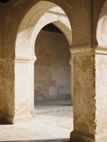 Close-up of hand-carved limestone arches framing a sun-drenched courtyard, warm morning light, soft shadows, 35mm film style