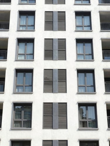 Straight-on eye-level architectural photograph of a modern apartment building exterior in Delhi, bright natural daylight, crisp realistic colors, sharp focus, 35mm.