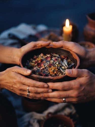Warm close-up of hands holding a clay bowl with dried petals, soft candlelight, deep twilight indigo background, 35mm photography