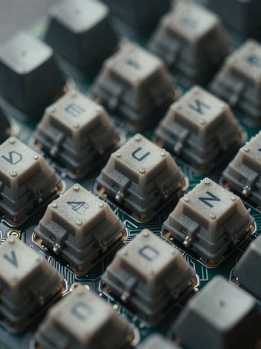 Moody macro close-up of a disassembled mechanical keyboard, showing tactile switches and internal circuit board, directional side-lighting with deep shadows, desaturated cool tones, 35mm