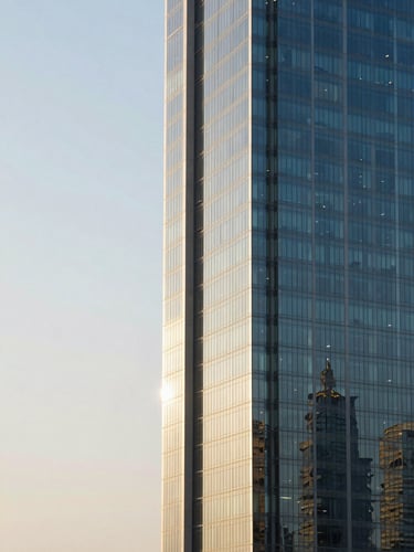 Sharp architectural shot of Riyadh's King Abdullah Financial District under high-contrast morning light, clean lines, steel and glass facade, negative space on the left.