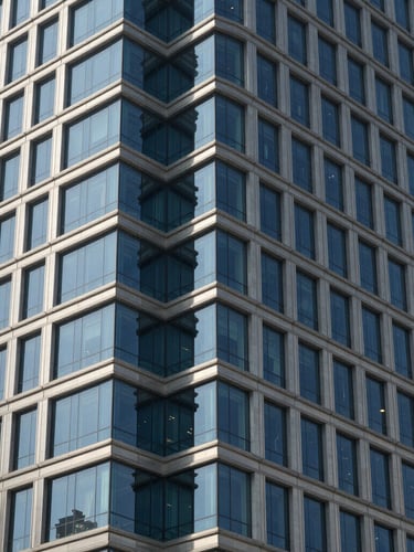 Close-up of structured steel and architectural glass corner of a modern skyscraper in Riyadh under crisp daylight
