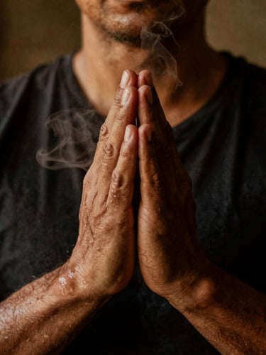 Close-up portrait of a practitioner's calloused hands in a prayer-like gesture, with visible sweat and steam, dramatically lit from behind with warm ember tones, deep shadows, 35mm film grain.