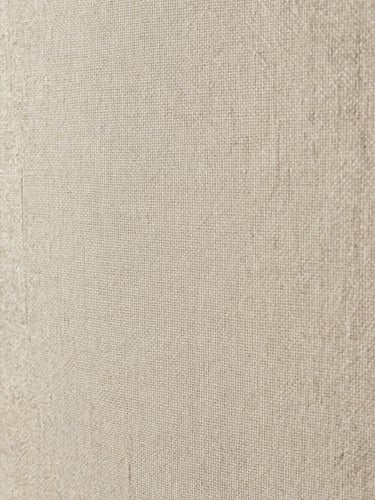 Extreme close-up of wallpaper weave texture, soft diffused north-light studio illumination revealing the grain and material weight of a linen-blend paper, warm neutral tones, abstract architectural surface detail, no people