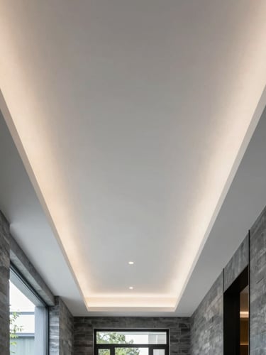 Symmetrical architectural shot of a minimalist luxury ceiling with perfectly linear recessed plaster-in LED profiles, bright natural daylight, cool slate tones.