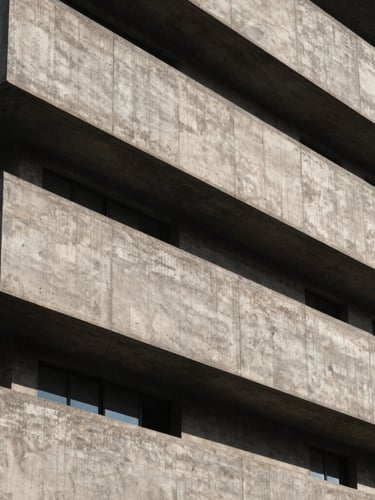 High-contrast architectural detail of a brutalist concrete building facade, sharp diagonal shadows from afternoon sun, minimalist and structural composition, 21:9 cinematic framing.