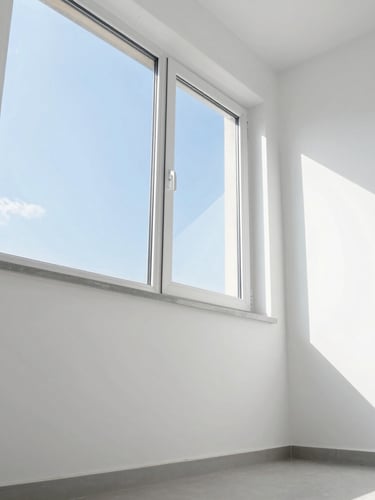 Low-angle architectural shot of a bright, empty room with freshly cleaned white walls, clinical daylight streaming through a large window, sharp focus