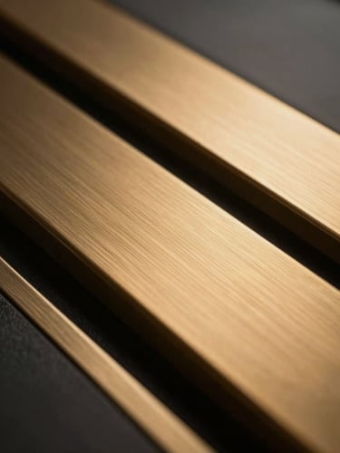 Extremely tight, shallow depth-of-field detail shot of brushed gold and dark matte steel, warm metallic reflections, luxury corporate material, 35mm