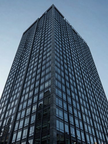 Low-angle architectural shot of a modern glass-and-steel corporate skyscraper in Mexico City, sharp cool-toned morning light, deep blue and slate gray shadows, 35mm editorial photography.