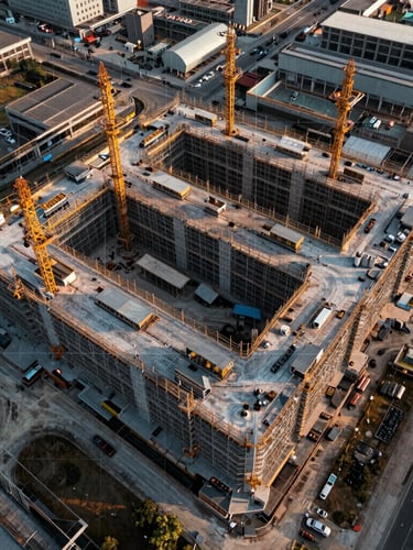 Top-down orthomosaic mapping of an industrial construction site, technical grid overlay, high clarity, crisp overcast daylight