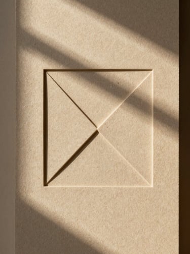 Macro shot of embossed warm sand paper stock with a clean geometric blind deboss, soft natural window light, architectural shadows