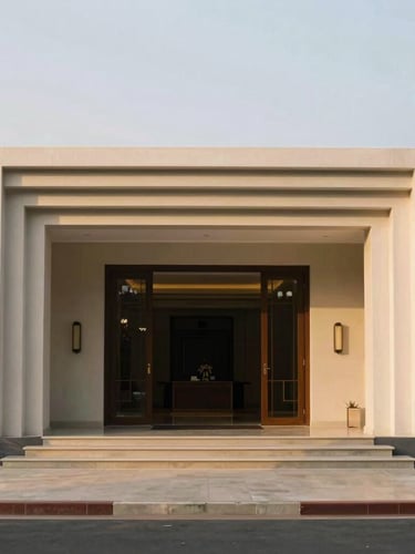 Wide architectural shot of a luxury Sri Lankan villa's entrance, emphasizing security and precision, soft golden hour light, clean geometric lines, muted earth tones, medium-format film