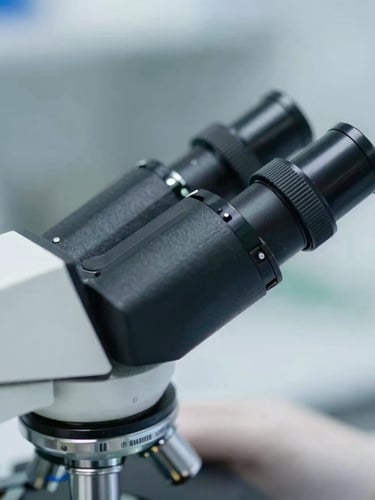 Close-up macro photography of a clinical researcher in a sterile environment, focusing on a microscope eyepiece, clean laboratory daylight, sharp focus.