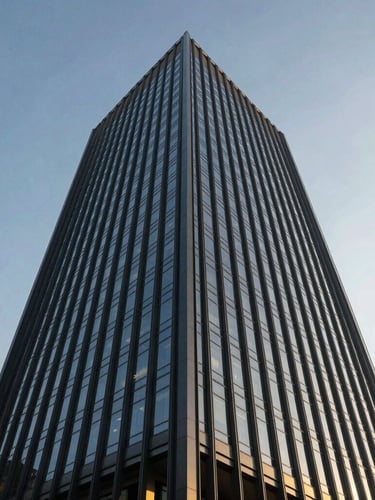 Low-angle architectural perspective of a towering modern corporate headquarters with glass facade reflecting a clear sky, crisp daylight, deep navy tones, 35mm.