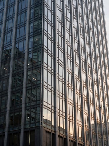 An architectural wide shot of a modern financial capital high-rise building reflected in glass, clean lines, soft natural lighting